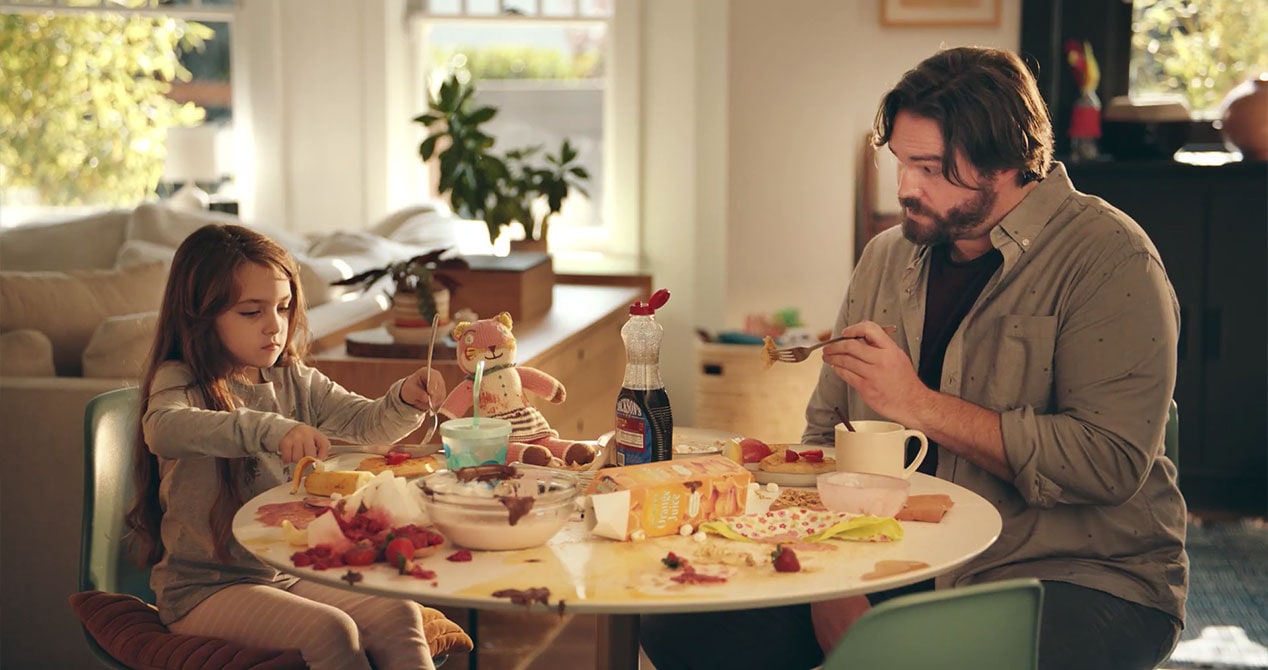 Little girl making her dad a messy breakfast