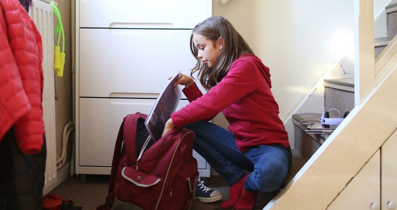 Girl packing her backpack